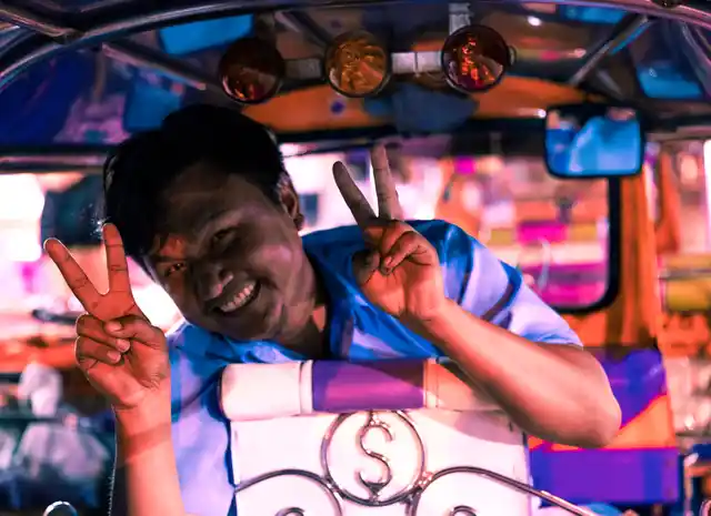 A tuk tuk driver poses for the camera. They are often very welcoming of tourists and will greet you with a smile.