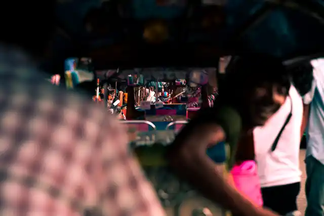 Tuk tuks are lined up near the entrance of Chatuchak market as the day comes to an end. Soon they will be calling for customers as the market closes and people are on their way back.