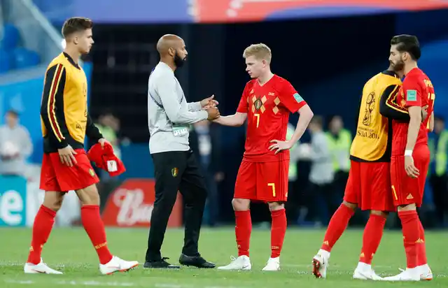 Belgium assistant coach Thierry Henry, second from left, greets his players at the end of the semifinal match between France and Belgium at the 2018 soccer World Cup in the St. Petersburg Stadium, in St. Petersburg, Russia