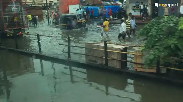 Commuter wades through water at Nallasopara.