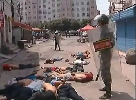 Chinese troops detain Uyghur Muslims in Xinjiang.