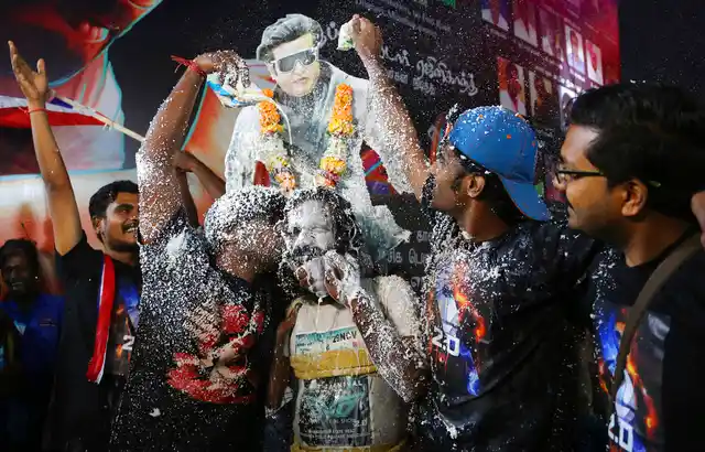 Fans of Tamil superstar Rajinikanth celebrate before the screening of ‘2.0’ on Thursday 29 November, outside a cinema hall in Mumbai.