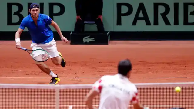 France’s Lucas Pouille (left) run to return the ball from Croatia’s Marin Cilic during the Davis Cup final between France and Croatia on Sunday, Novemeber 25, 2018 in Lille.