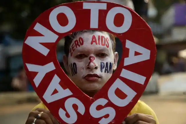 Ahead of the World Aids Day on 1 December, an activist holds a prop during an awareness campaign in Kolkata, on Friday 30 November. 
