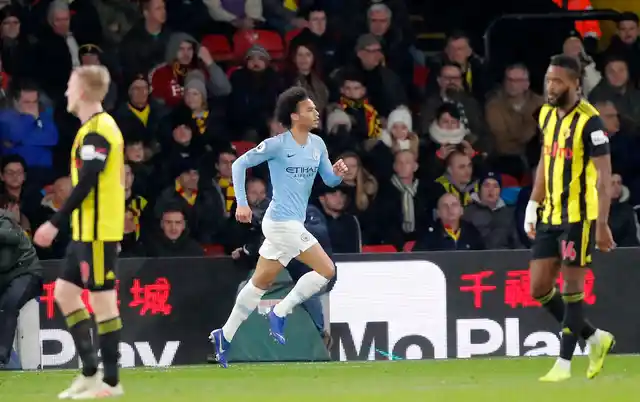 Manchester City’s Leroy Sane, center, celebrates after scoring his side’s opening goal during the English Premier League soccer match between Watford and Manchester City.
