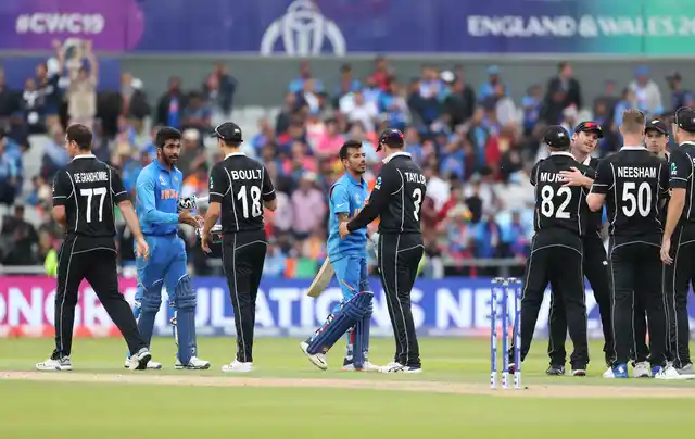 New Zealand players greet Indian players after the match at Old Trafford. 