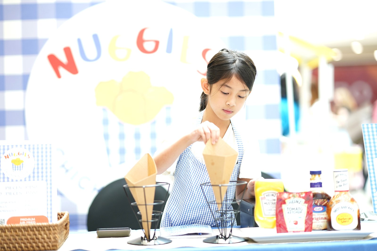 A budding entrepreneur readies her products for display at the recent Kiddo-preneur Fair held at The Podium.