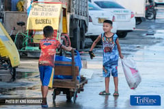 Children on the streets play as they sift through junk and dream of the future
