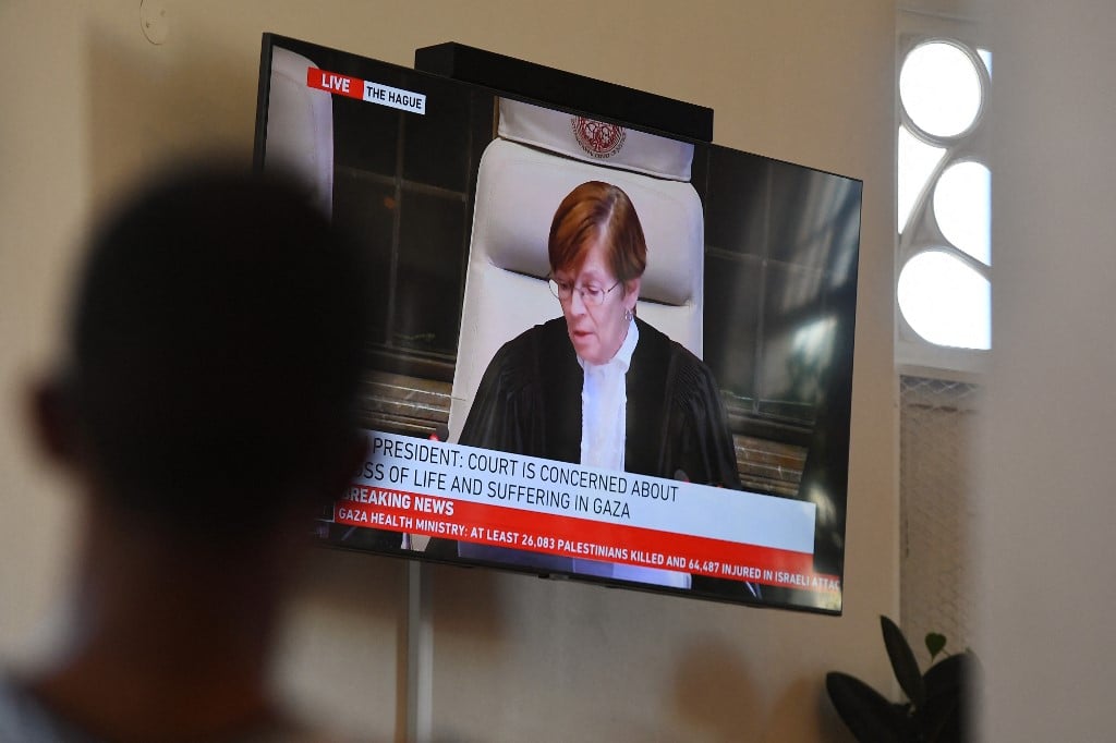 People gather to watch the International Court of Justice (ICJ) ruling of the case against Israel brought by South Africa in The Hague at the Bertha House in Cape Town on January 26, 2024. South African lawyers presented their case at the UN's top court in The Hague, where South Africa lodged an urgent appeal to force Israel to "immediately suspend" its military operations in Gaza. The International Court of Justice (ICJ) ruled on January 26, 2024 that it has jurisdiction over the genocide case.