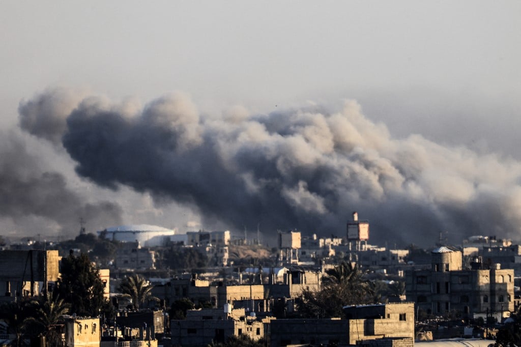 This photograph taken on 22 January 2024 from Rafah, shows smoke billowing during Israeli bombardment over Khan Yunis in the southern Gaza Strip, amid ongoing battles between Israel and the Palestinian group Hamas.