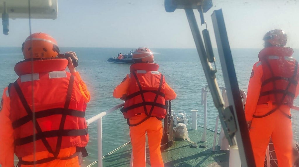 (FILES) This handout photo taken on 14 February 2024 by the Taiwan Coast Guard and released on 15 February shows Taiwanese Coast Guard staff surrounding an overturned Chinese speed boat near the Kinmen Islands.