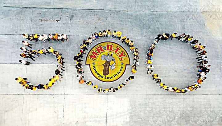 MR.DIY Philippines employees commemorate their 500th milestone with a remarkable human formation depicting the number 500.