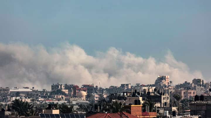 This picture taken from Rafah shows smoke billowing following Israeli bombardments over Khan Yunis in the southern Gaza Strip on February 13, 2024, amid the ongoing conflict between Israel and the Palestinian Hamas militant group.