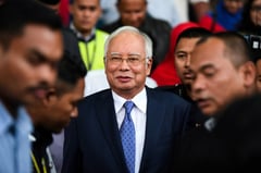 Malaysia's ex-PM Najib jail term halved to six years