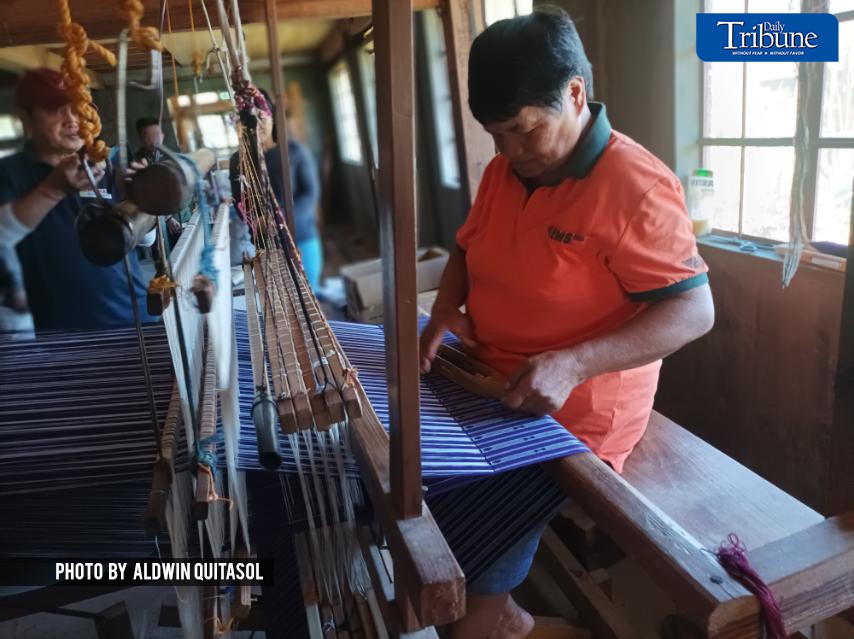 Sagada elder Evelyn Bacolong makes sure of the right combinations of colors to come up with the gebyine design of Sagada-weaved fabric.
