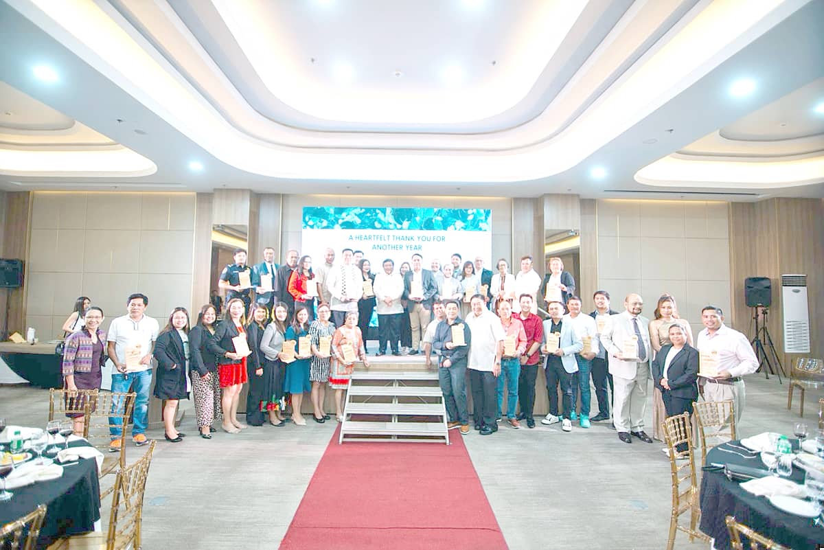 Awardees during the Partners' Recognition Night pose alongside MORE Power President and CEO, Roel Z. Castro.