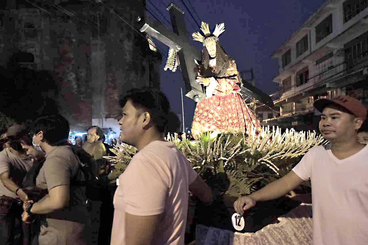 Devotees in Ilocos Norte line the streets to witness the procession of images of saints and the re-enactment of the Crucifixion of Christ in Laoag City on 22 March.