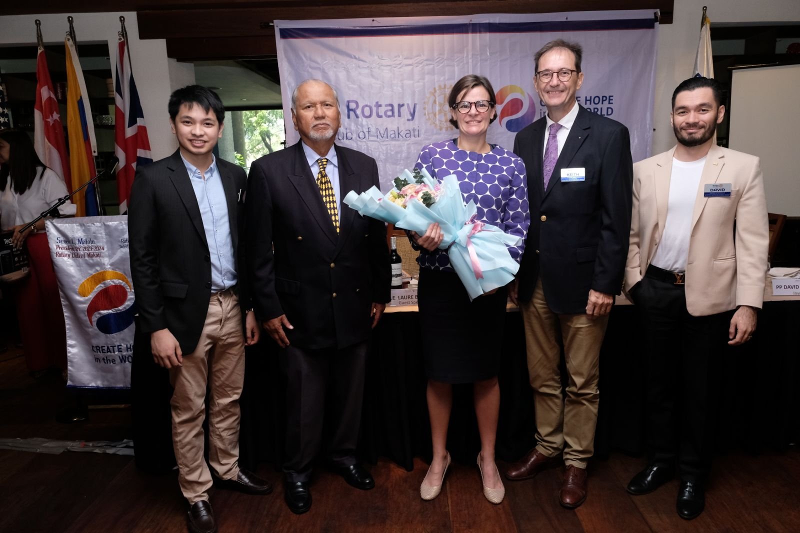 Rotary Club of Makati's guest of honor and speaker, British Ambassador to the Philippines Laure Beufils (center) stands with a bouquet of flowers given to her by RC Makati president Bing Matoto (2nd from left) after delivering her speech at the Club's weekly meeting last 27 February 2024 at The Peninsula Manila, in Makati City. Also in the photo are RC Makati members and officers (from left) Anton Cabrera, president-elect Keith Harrison and past president David Ackerman.