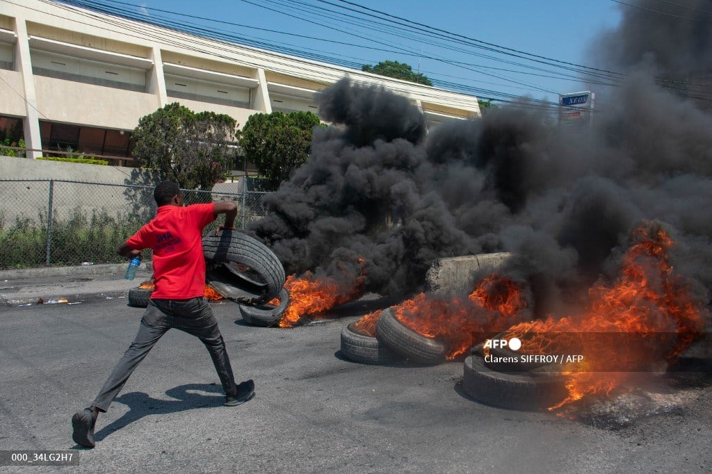 (FILES) A protester burns tires during a demonstration following the resignation of its Prime Minister Ariel Henry, in Port-au-Prince, Haiti, on 12 March 2024.