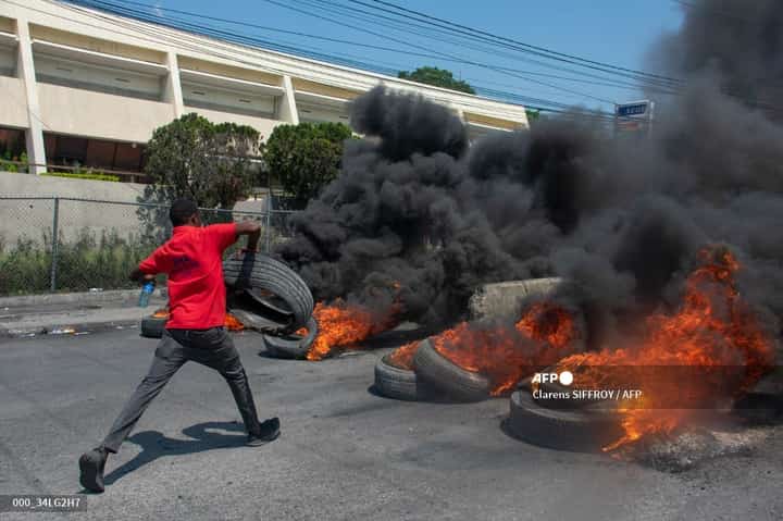 (FILES) A protester burns tires during a demonstration following the resignation of its Prime Minister Ariel Henry, in Port-au-Prince, Haiti, on 12 March 2024.