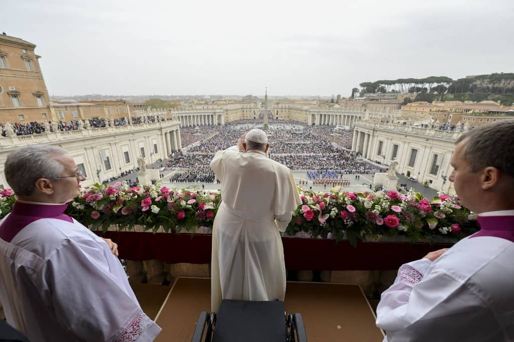 This photo taken and handout on 31 March 2024 by The Vatican Media shows Pope Francis during the Easter 'Urbi et Orbi' message and blessing to the City and the World from the central loggia of St. Peter's basilica in The Vatican.