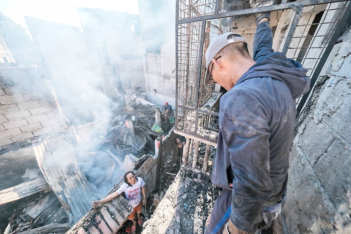 FIRE victims assist each other as they try to salvage whatever is left of their homes in Barangay 598, Zone 69, Old Sta. Mesa, Manila last 22 February.