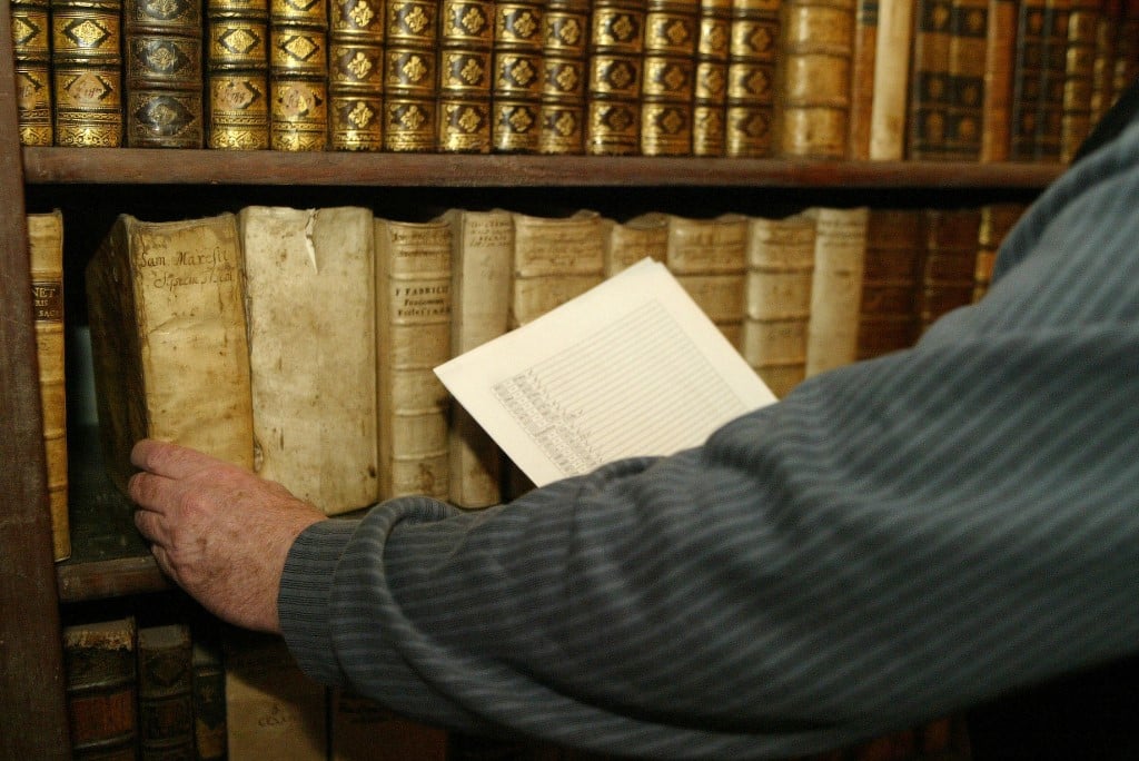 (FILES) Director of the Calvinistic College Library in Sarospatak, Denes Dienes shows the empty spaces left by books missing in the library on 08 February 2006 in Sarospatak 230km east from Budapest. 138 books from the 14th and 15th century will arrive back to the library, after Russian lawmakers voted Friday to give back to Hungary a valuable book collection confiscated by Soviet troops during World War II and kept in Russia as compensation for wartime losses.