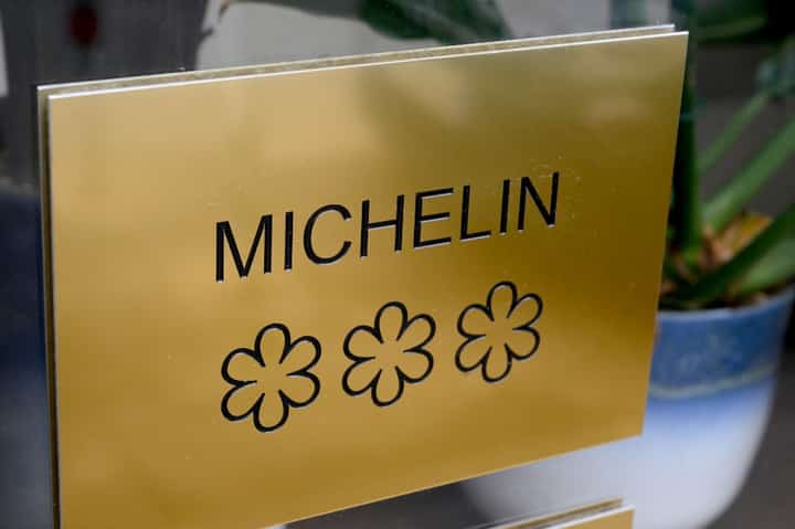This photograph taken on February 15, 2024 shows a plaque displaying the three stars of the Michelin guide, the highest award of the French gastronomy, on the door of Alexandre Mazzia's AM restaurant.