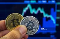 (FILES) A picture taken on 6 February 2018 shows a person holding a visual representation of the digital crypto-currency Bitcoin, at the "Bitcoin Change" shop in the Israeli city of Tel Aviv.