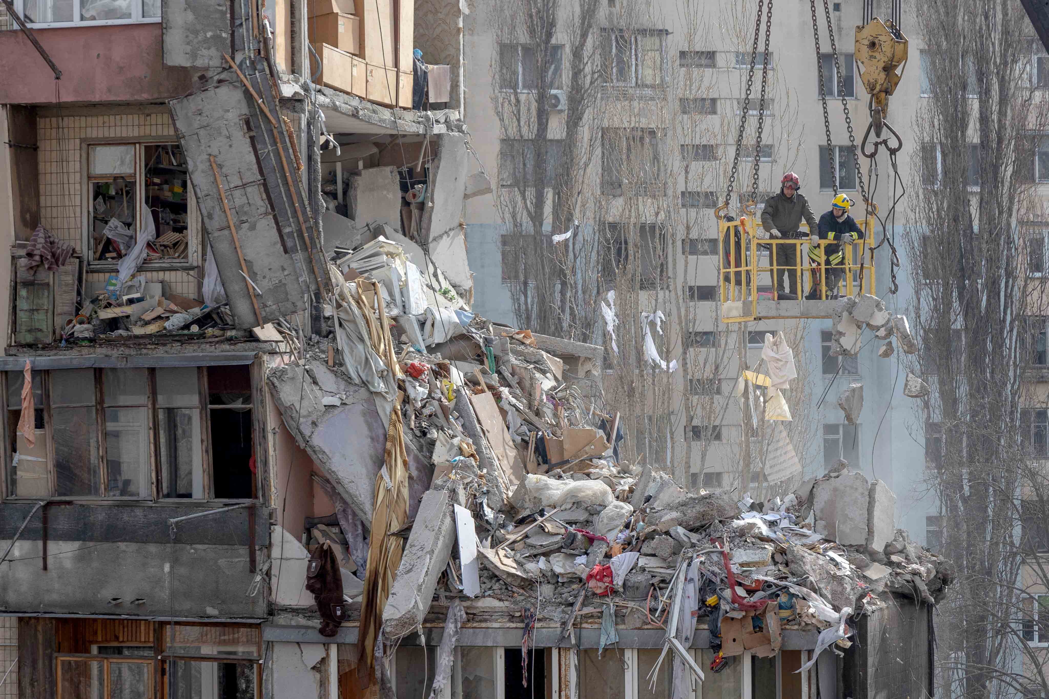 Rescuers clear debris from a multi-story building heavily damaged following a drone strike, in Odesa, amid the Russian invasion of Ukraine. Two more bodies have been found following a deadly Russian drone strike on the southern port city of Odesa, Ukraine said. The deaths of a woman and her eight-month-old baby take the toll to 10 from the strike.