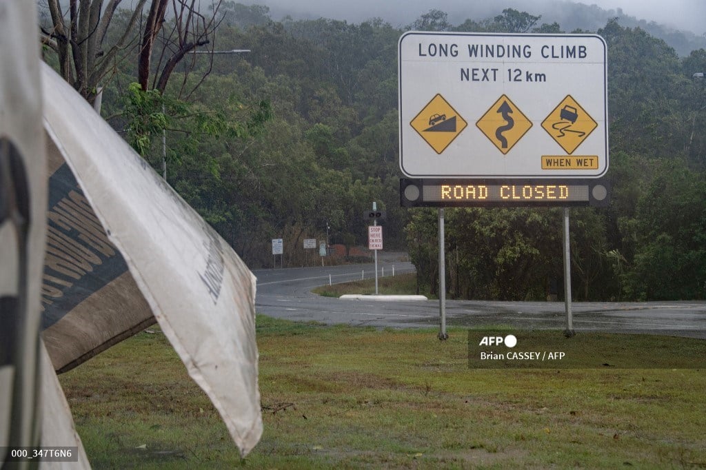 (FILES) Signage showing a road closure is seen as Cyclone Jasper approaches landfall near Cairns in far north Queensland on 13 December 2023.