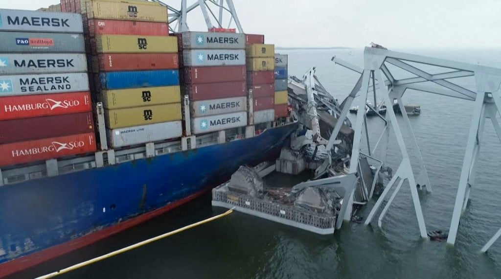 This handout screengrab courtesy of the National Transportation Safety Board taken on 27 March 2024, shows part of the steel frame of the Francis Scott Key Bridge sitting on top of the container ship Dali after the bridge collapsed in Baltimore, Maryland, on 26 March 2024. A major bridge collapsed in Baltimore on 26 March 2024, blocking one of the busiest US commercial harbors, after a heavily laden cargo ship lost power and smashed into a support column despite desperate attempts to stop in time. Six people — all members of a nighttime construction crew repairing potholes on the Francis Scott Key Bridge — were missing and feared dead, according to officials and media reports.