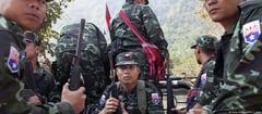 Myanmar border hub residents flee to Thailand amid gunfire, explosions