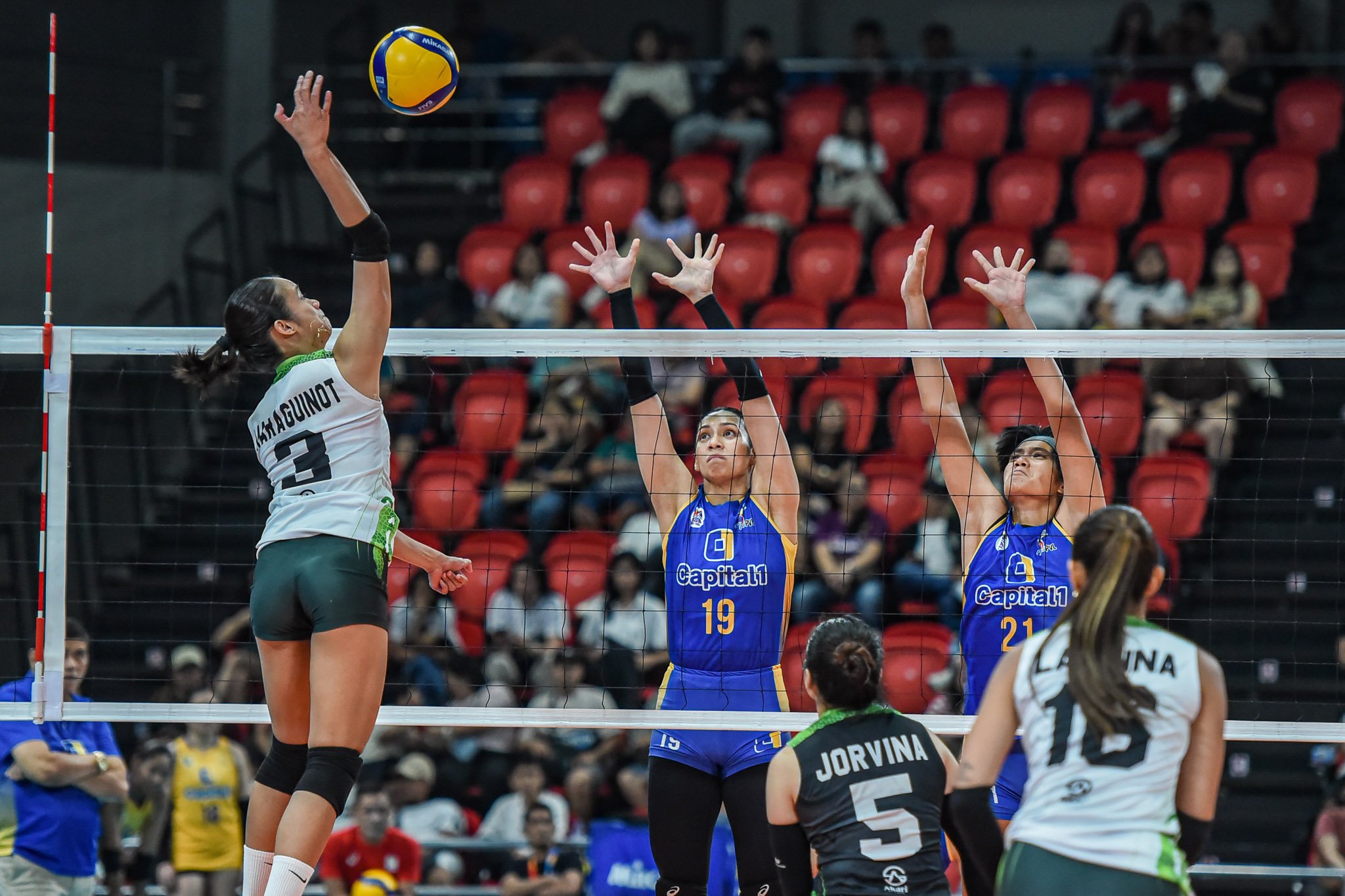 CAMILLE Victoria of Nxled attacks the defense of Jorelle Singh and Shirley Salamagos of Capital1 during their PVL All-Filipino Conference match yesterday. The Chameleons prevailed, 25-13, 25-23, 25-22.
