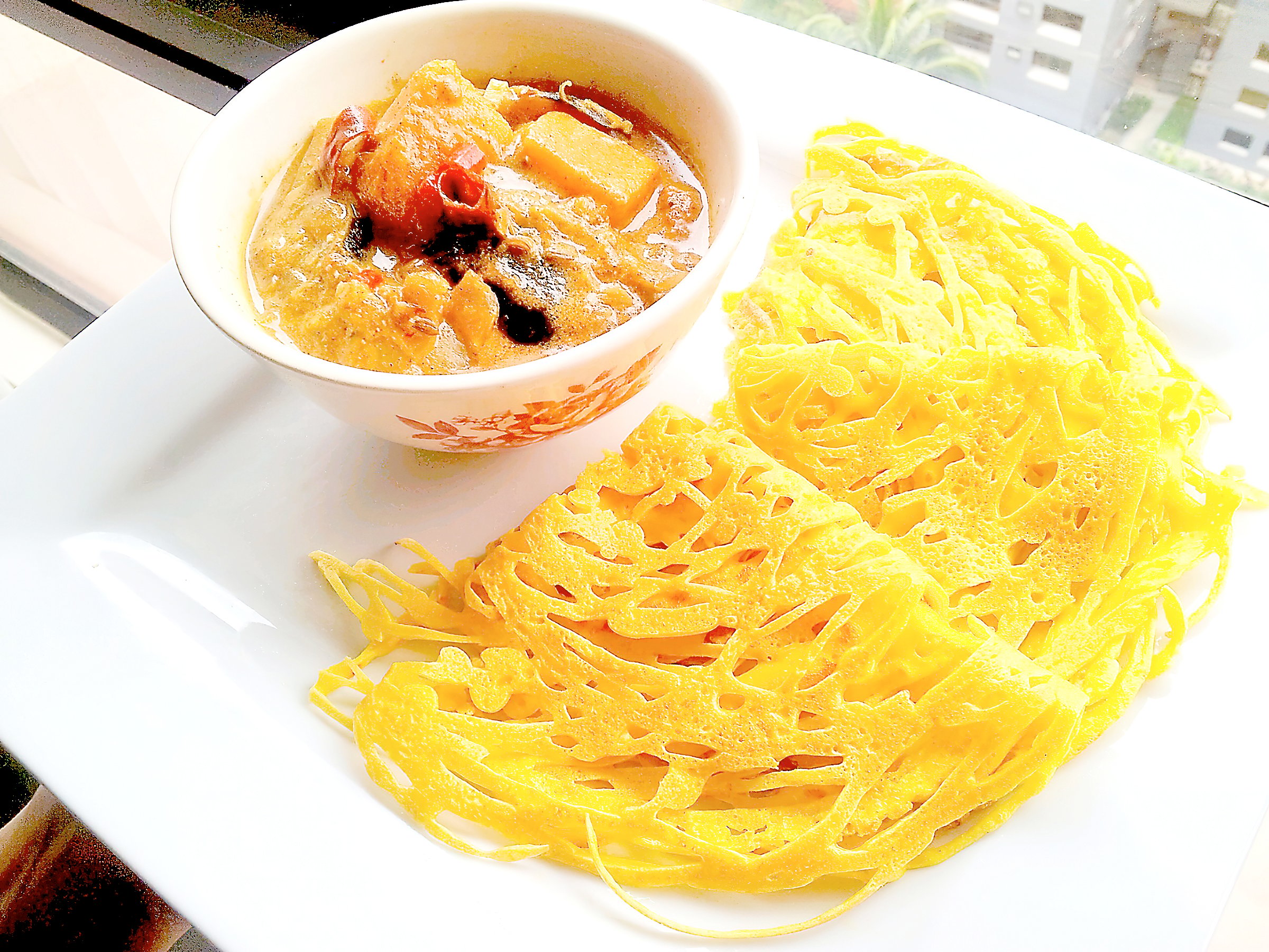 Roti jala are lace pancakes served with aromatic chicken curry in Malaysia and Mindanao.