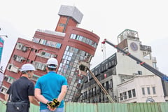 Food, flowers, incense offered for smooth demolition of tilting building