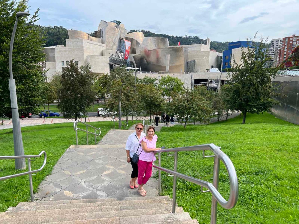 Honey Jarque-Loop and Adela Jarque with the Guggenheim Museum Bilbao at a distance, in all its glory