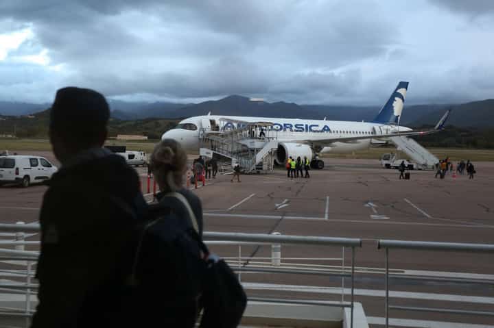 Travellers walk to an Air Corsica plane at the Napoleon Bonaparte airport in Ajaccio, on the French Mediterranean island of Corsica, on 22 April 2024. "Serious failures" in luggage and passenger screening at Ajaccio airport have been reported since "December 2022", the prefect of Corsica indicated on 23 April 2024, as the tourist season approaches and the France's Vigipirate security alert have been raised to its highest level.