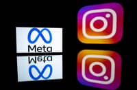 (FILES) This picture taken on 12 January 2023 in Toulouse, southwestern France shows a smartphone and a computer screen displaying the logos of Instagram app and its parent company Meta.