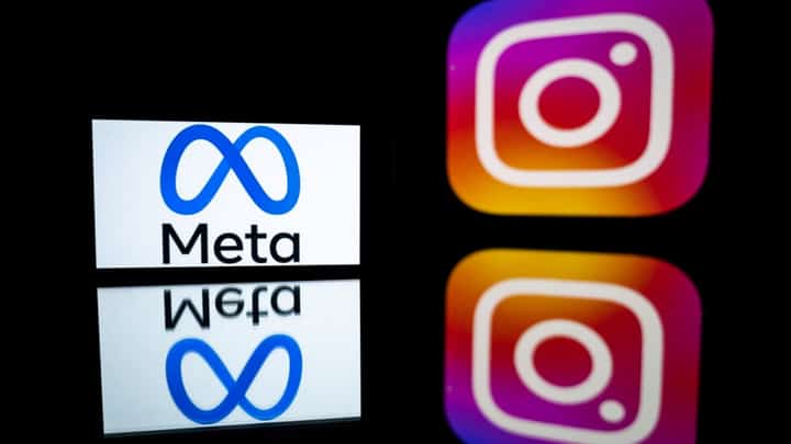 (FILES) This picture taken on 12 January 2023 in Toulouse, southwestern France shows a smartphone and a computer screen displaying the logos of Instagram app and its parent company Meta.