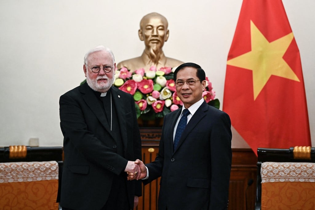 Vietnam's Foreign Minister Bui Thanh Son (R) shakes hands with with Vatican Secretary for Relations with States Archbishop Paul Gallagher (L) at the Foreign Ministry in Hanoi on 9 April 2024. The Vatican's de facto foreign minister arrived in Vietnam on 9 April 2024 hoping to ease strained ties between the communist Southeast Asian nation and the Holy See, and pave the way for a potential visit by Pope Francis.