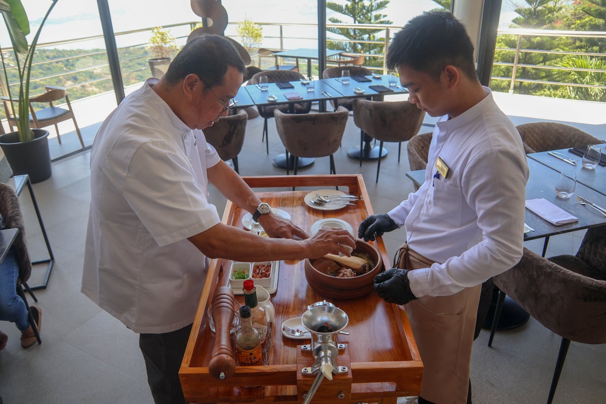CHEF Ariel Manuel and staff Marc Bernard Villanueva preparing the beef tartare with apple kimchi.
