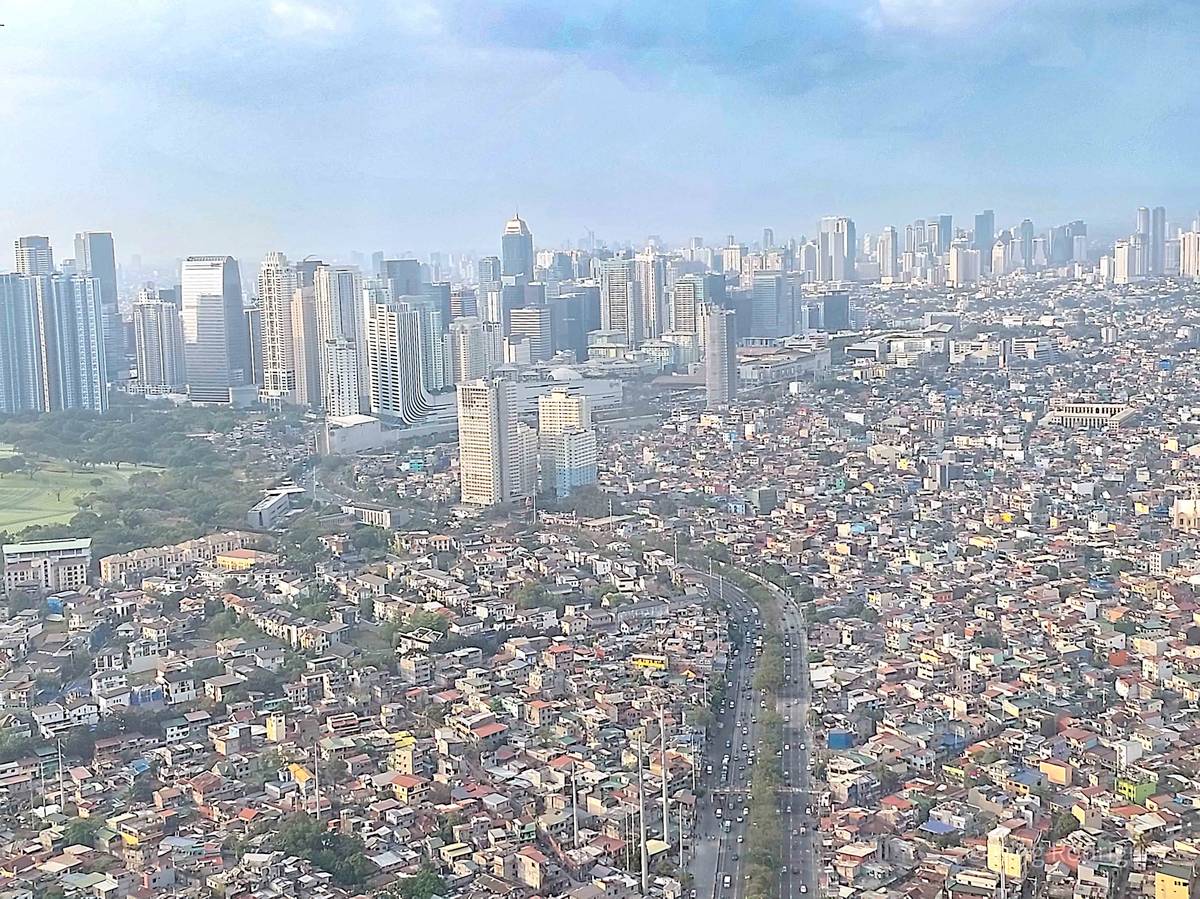 An eagle’s eye view of Metro Manila’s skyscrapers captured in a moving airline at sunrise.
