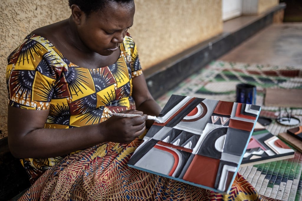 A genocide survivor belonging to the Kakira Imigongo Cooperative paint pieces of traditional Imigongo cow dung art in Kirehe on 4 April 2024. A 200-year-old Tutsi art form made with cow dung, Rwanda's Imigongo painting tradition has experienced a revival in the Great Lakes nation three decades after the 1994 genocide, becoming a symbol of culture and unity. Known for its raised black and white patterns, imigongo is widely believed to have been invented by a Tutsi prince in the 19th century.