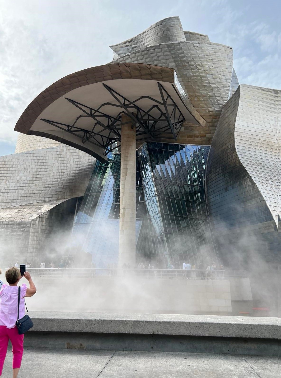A tourist snaps a photo of the fountain