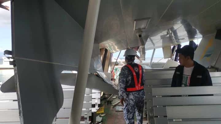 THE damaged FastCat M19 is inspected by a Coast Guard.