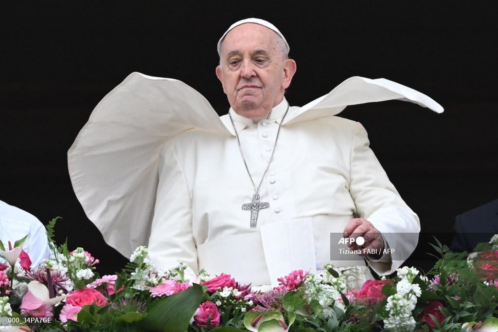 The wind lifts Pope Francis mantilla as he stands at the central loggia of St. Peter's basilica during the Easter 'Urbi et Orbi' message and blessing to the City and the World as part of the Holy Week celebrations, in the Vatican on 31 March 2024. Pope Francis, 87, will travel to Indonesia, Papua New Guinea, East Timor and Singapore in September, the Vatican announced on 12 April 2024.