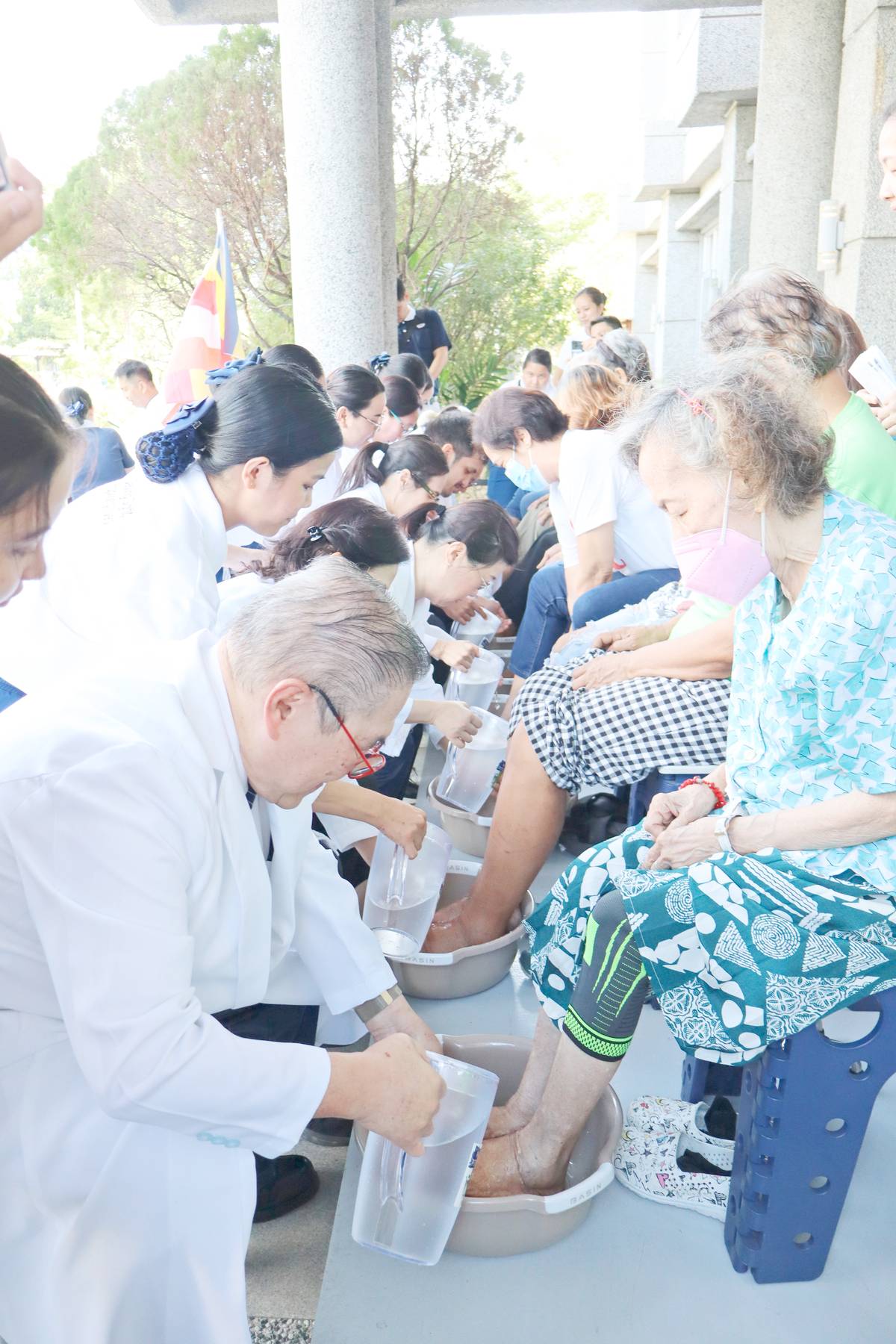 TZU Chi Medical Foundation Philippines president Dr. Antonio Say (left) and other eye doctors wash the feet of patients as part of the humanitarian organization's celebration of Mother's Day and its 58th anniversary at the Tzu Chi Eye Center in Sta. Mesa, Manila on 10 May.