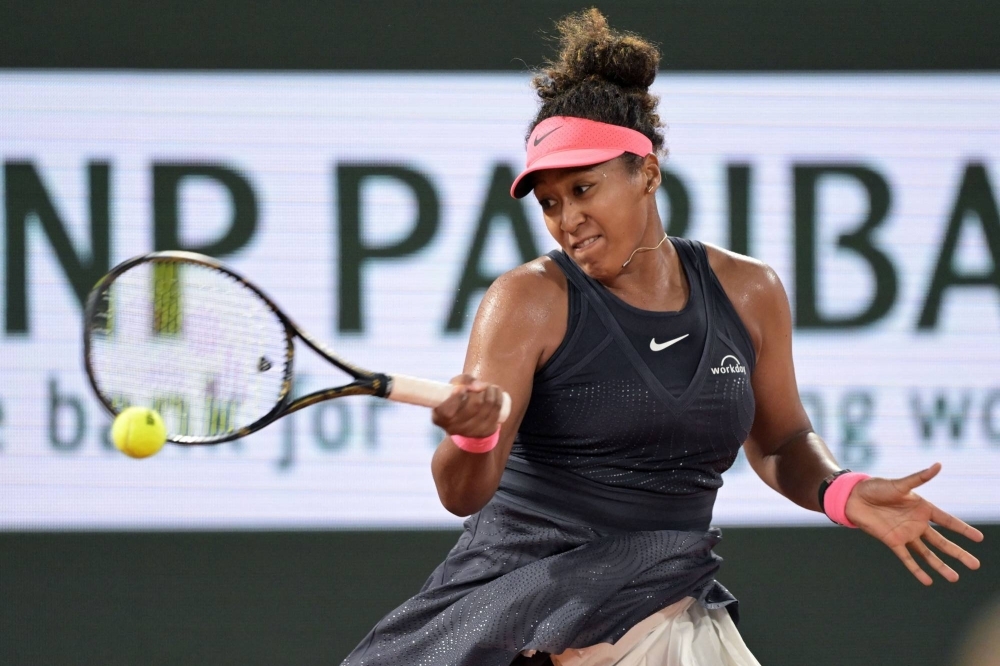 Naomi Osaka hits a return against Iga Swiatek during their second-round match at the French Open at Roland Garros in Paris on Wednesday.