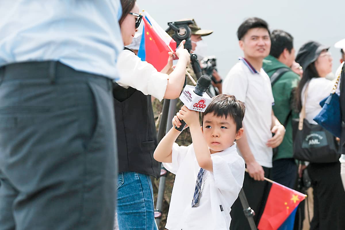 A media practitioner’s kid assisting her mom while covering an event at the port area in Manila last year.